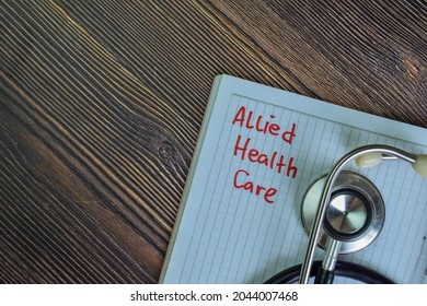 Allied Health Care Write On A Book With Keywords Isolated On Wooden Table.