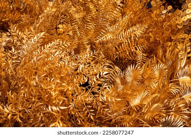 Allover texture of golden leaves and ferns. Background from golden shiny decorations. - Shutterstock ID 2258077247
