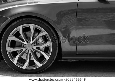 Alloy car wheel rim with break and new tire close up view