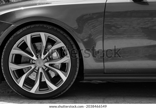 Alloy\
car wheel rim with break and new tire close up\
view