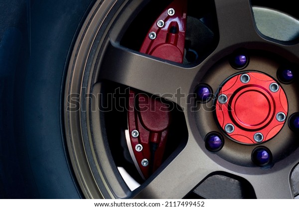 Alloy gold car\
wheels with red brake\
calipers.