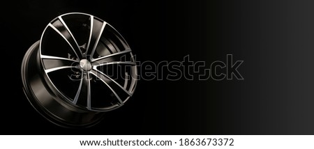 alloy wheel black with a white groove, 6 beams for SUVs and crossovers, close-up on a black background. panoramic layout for advertising a tire spare parts store, panorama.