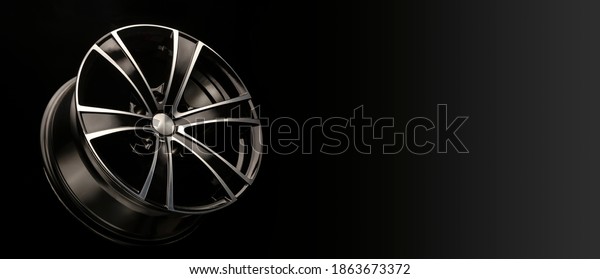 alloy wheel black with\
a white groove, 6 beams for SUVs and crossovers, close-up on a\
black background. panoramic layout for advertising a tire spare\
parts store, panorama.
