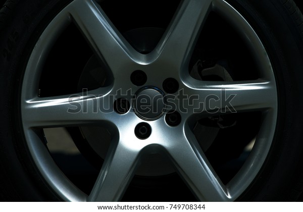 Alloy wheel of a luxury\
car dark toned