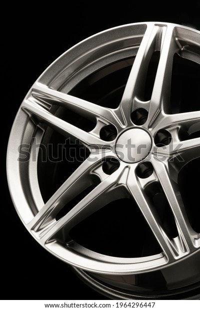 alloy wheel, sporty alloy,\
star-shaped on dark background, details close-up vertical\
photo