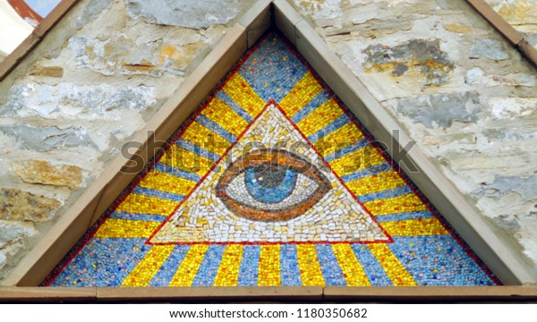 All-seeing eye of God - a mosaic of wall background medieval church. Eye of Providence - famous symbol of Masons and Illuminati. 