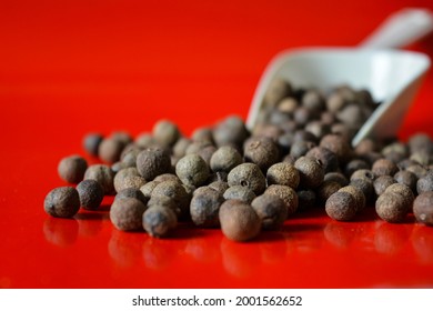 Allspice Berries In Red Background