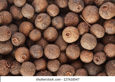 Allspice (jamaica pepper) berries texture, background full frame. Used as a spice in cuisines all over the world. The plant is also used in medicine.