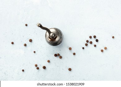 Allspice, Jamaica Pepper. Black Peppercorns With A Vintage Pepper Mill, Overhead Shot With Copy Space