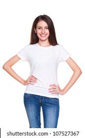 alluring young woman in white t-shirt and blue jeans posing over white background