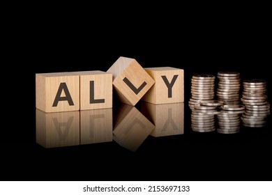 Ally. Wooden Cubes. Black Background. Stacks With Coins. Inscription On The Cubes Is Reflected From The Surface Of The Table. Business Concept