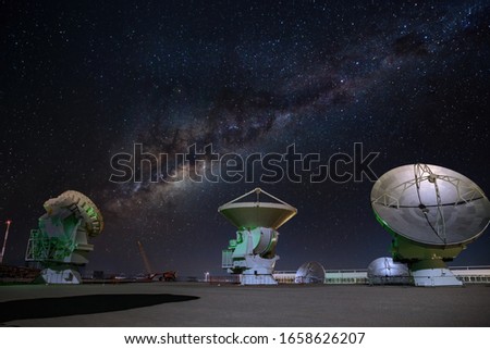 ALMA radio astronomy dishes watching the sky with milky way above