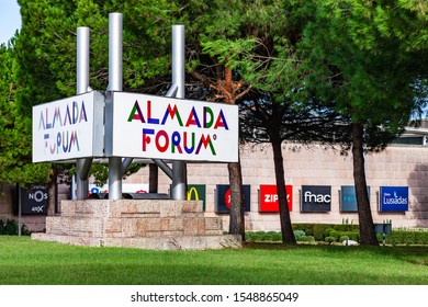 Almada, Portugal - October 24, 2019: Advertisement for the Almada Forum shopping center with the mall in background. Almada Forum is one of the largest shopping malls in Portugal close to Lisbon.