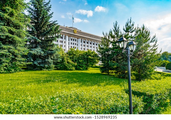 Almaty City Mayor Office\
Picturesque Breathtaking Park View with Street Lamp on a Sunny Blue\
Sky Day