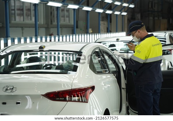 Almaty,\
Kazakhstan - 02.15.2022 : The car assembly quality controller\
records the data after the check. Hyundai\
Factory