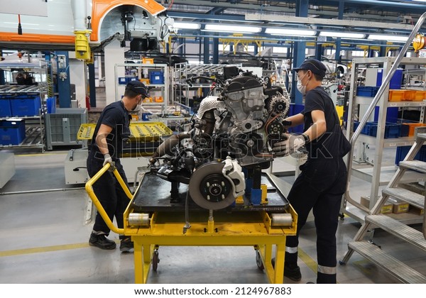 Almaty, Kazakhstan - 02.15.2022 : Workers\
move the car engine to check. Hyundai\
Factory