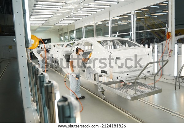 Almaty, Kazakhstan - 02.15.2022\
: Workers paint and polish the exterior of the car. Hyundai\
Factory