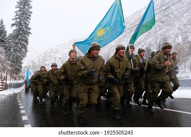 Almaty, Kazakhstan - 02.25.2021 : Military exercises of various troops. Soldiers with flags lined up before the uphill race.