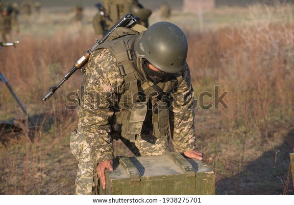 Almaty, Kazakhstan -\
04.14.2014 : Soldiers carry wooden crates with light mines during\
the exercise.