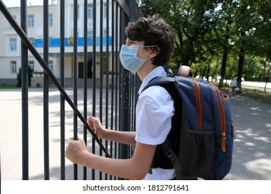 Almaty / Kazakhstan - 08.31.2020 : 
A Masked Middle School Student Stands Next To The School Fence.