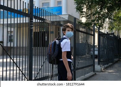 Almaty / Kazakhstan - 08.31.2020 : 
A Masked Middle School Student Stands Next To The School Fence.