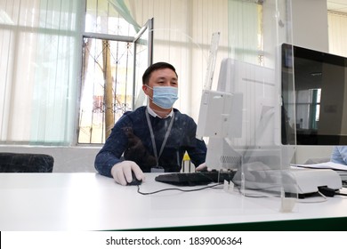 Almaty / Kazakhstan - 10.19.2020 : Citizen Service Center. A Government Employee Wearing A Mask And Gloves Works During Quarantine.