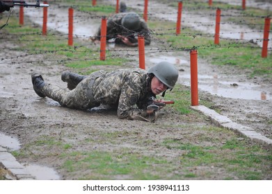 Almaty, Kazakhstan - 10.21.2014 : Soldiers Pass An Obstacle Course During A Military Exercise In The Rain