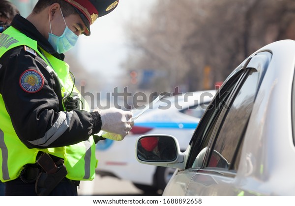 Almaty, Kazakhstan 31/03/2020:\
checkpoint in the city of Almaty. Kazakhstan police stand on the\
road  and inspect drivers because of the coronavirus\
pandemic