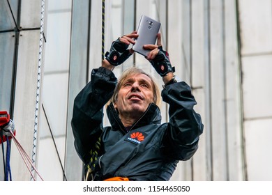 Almaty / Kazakhstan - Apr 2016: Alain Robert, French Climber Widely Known As Spiderman, Climbed Up One Of The Tallest Buildings In The City.