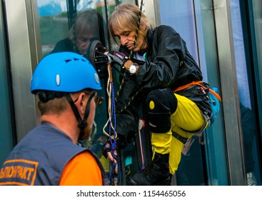 Almaty / Kazakhstan - Apr 2016: Alain Robert, French Climber Widely Known As Spiderman, Climbed Up One Of The Tallest Buildings In The City.