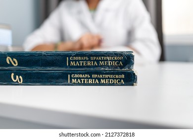 Almaty, Kazakhstan - July 12, 2021: Materia Medica by John Henry Clarke books in Russian lie on table with the doctor in blur background