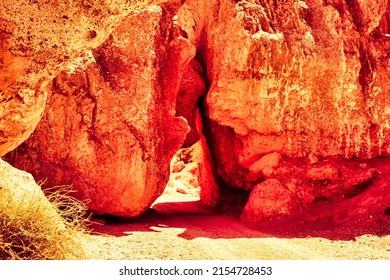 Almaty, Kazakhstan - June 16 2017 : Red Sandstone Rocks Keep A Little Bit Of Space So A River Or Car Is Able To Pass Through