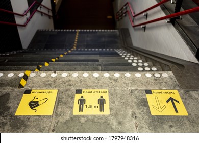 ALMELO, NETHERLANDS - Jul 28, 2020: Signs In Train Station Stairs Spelling Out Behaviour Conduct Rules During COVID-19 Virus Outbreak. TRANSLATION: 'FACE MASK. KEEP DISTANCE. KEEP RIGHT'