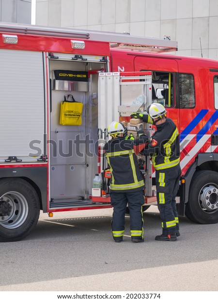 ALMERE, NETHERLANDS - 12 APRIL 2014:\
Firefighters at work in an enacted emergency scene during the first\
National Security Day held in the city of\
Almere