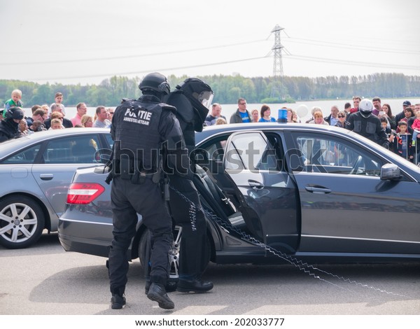 ALMERE, NETHERLANDS - 12 APRIL 2014: SWAT team\
during a demonstration of an enacted robbery at the first National\
Security Day held in the city of\
Almere