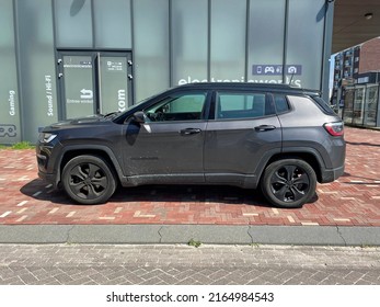 Almere, the Netherlands - June 7, 2022: Black Jeep Compass parked on a public parking lot. Nobody in the vehicle.