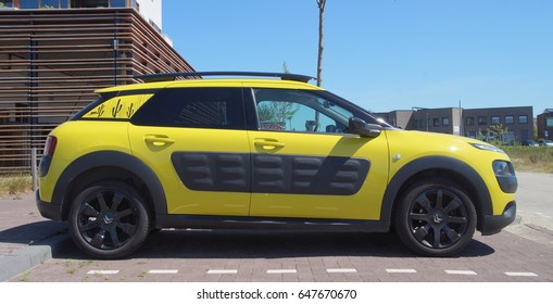 Almere, The Netherlands - May 25, 2017: Yellow Citroën C4 Cactus Parked In A Public Parking Lot In The City Of Almere. 