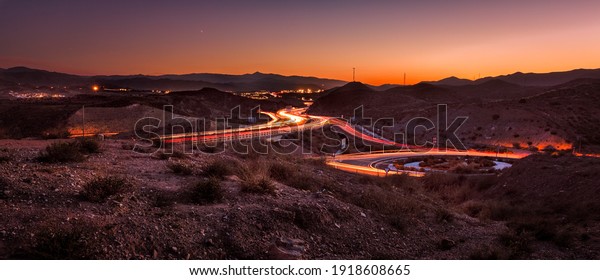 Almeria landscape at\
sunset with car trails