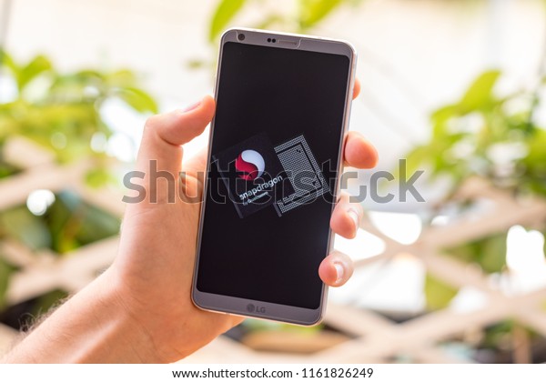 Almeria,\
Spain - August 18, 2018: Holding a LG G6 Android smartphone on hand\
with Qualcomm Snapdragon processor on\
screen