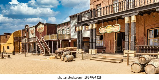 ALMERIA, SPAIN - CIRCA AUGUST 2020: Vintage Far West town with saloon. Old wooden architecture in Wild West with blue sky background.