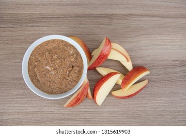 Almond Butter In Small White Bowl And Apple Slices For Snacking