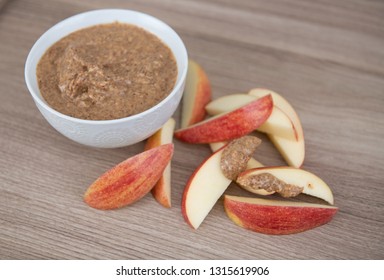 Almond Butter In Small White Bowl And Apple Slices For Snacking