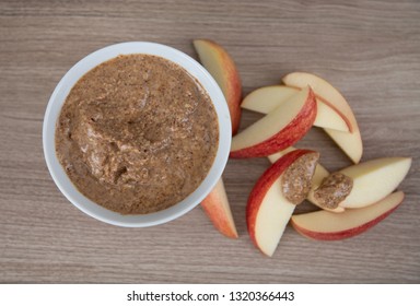 Almond Butter In Small White Bowl And Apple Slices For Snacking