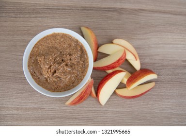 Almond Butter In Small White Bowl And Apple Slices For Snacking