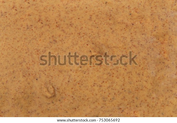 Almond butter spread on bread\
across entire frame showing only the almond butter. Almonds are\
California\'s third-leading agricultural product in the United\
States.