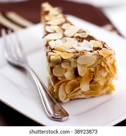 Almond cake. Piece of Cake on a Plate. Sweet food. Sweet dessert. Food bakcground. Close up. 
