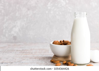 Almond milk in a bottle on a light background