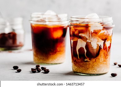 Almond Milk Cold Brew Coffee Latte In Glass Jar On A Gray Stone Background