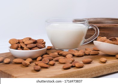 Almond Milk In Cup With Almond Nuts On Wooden Background