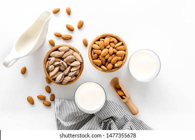 Almond Milk In Glass With Almonds On White Background Top View